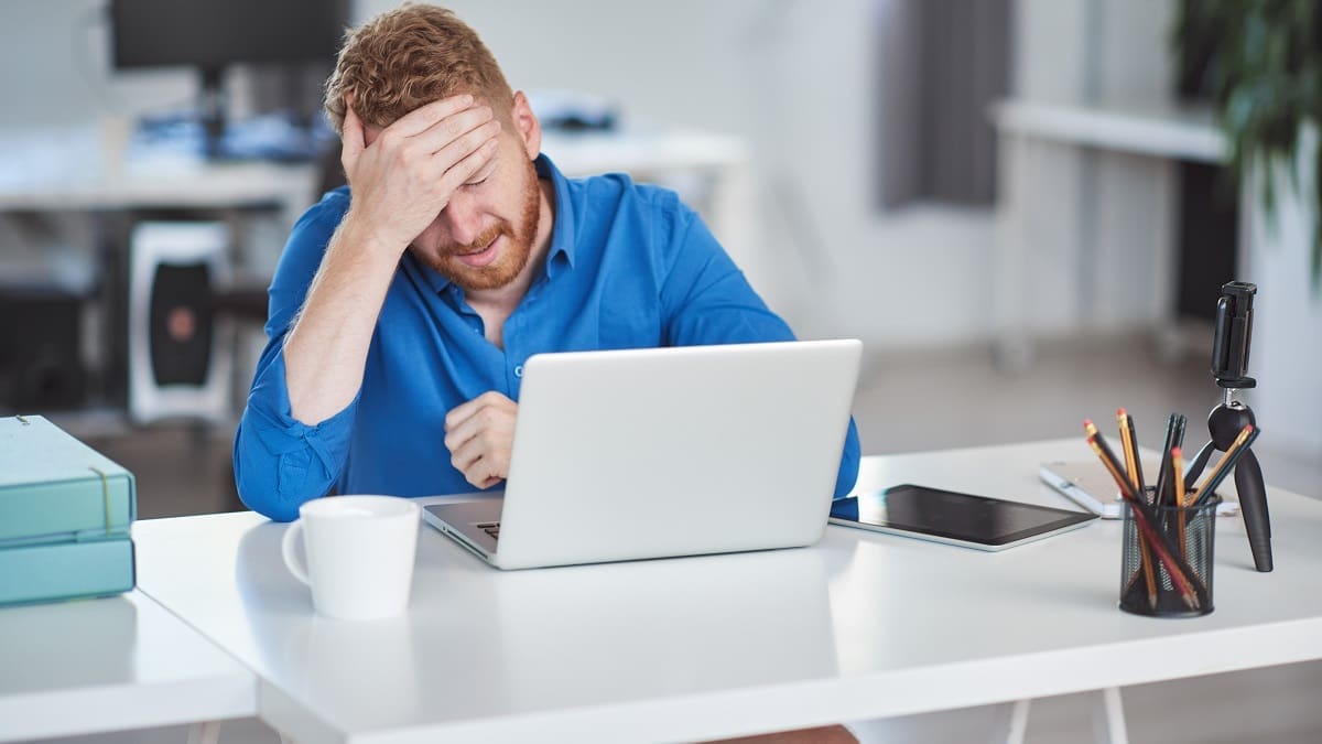 Young serious employee having problems at work. Bad day at work Protection and redundancy features of Passive Optical LAN